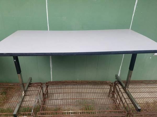 Two heavy-duty adjustable tables / desks