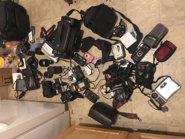 Large box full of cameras accessories and lenses