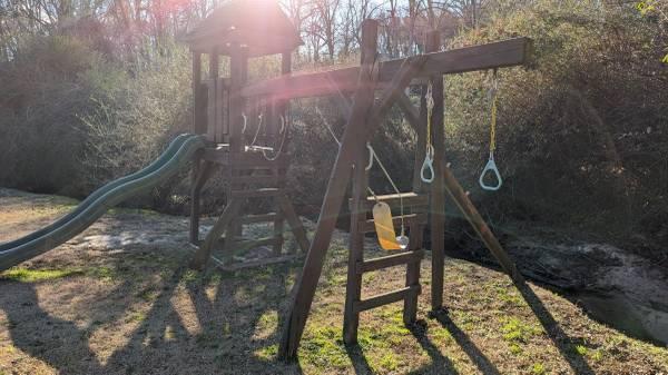 Wooden playset with slide and swings